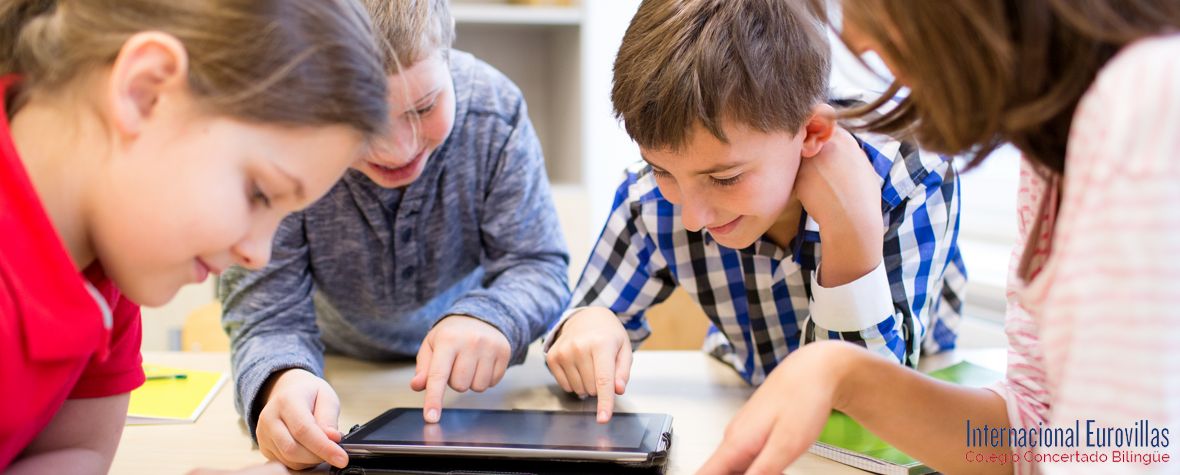 group of school kids with tablet pc in classroom